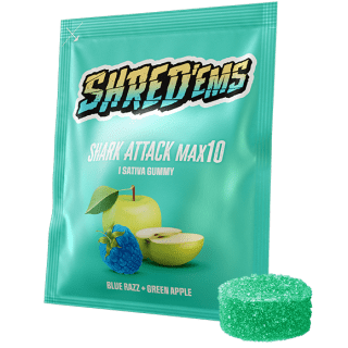 A green bag of Shred'ems MAX10 Shark Attack, with a gummy beside it.